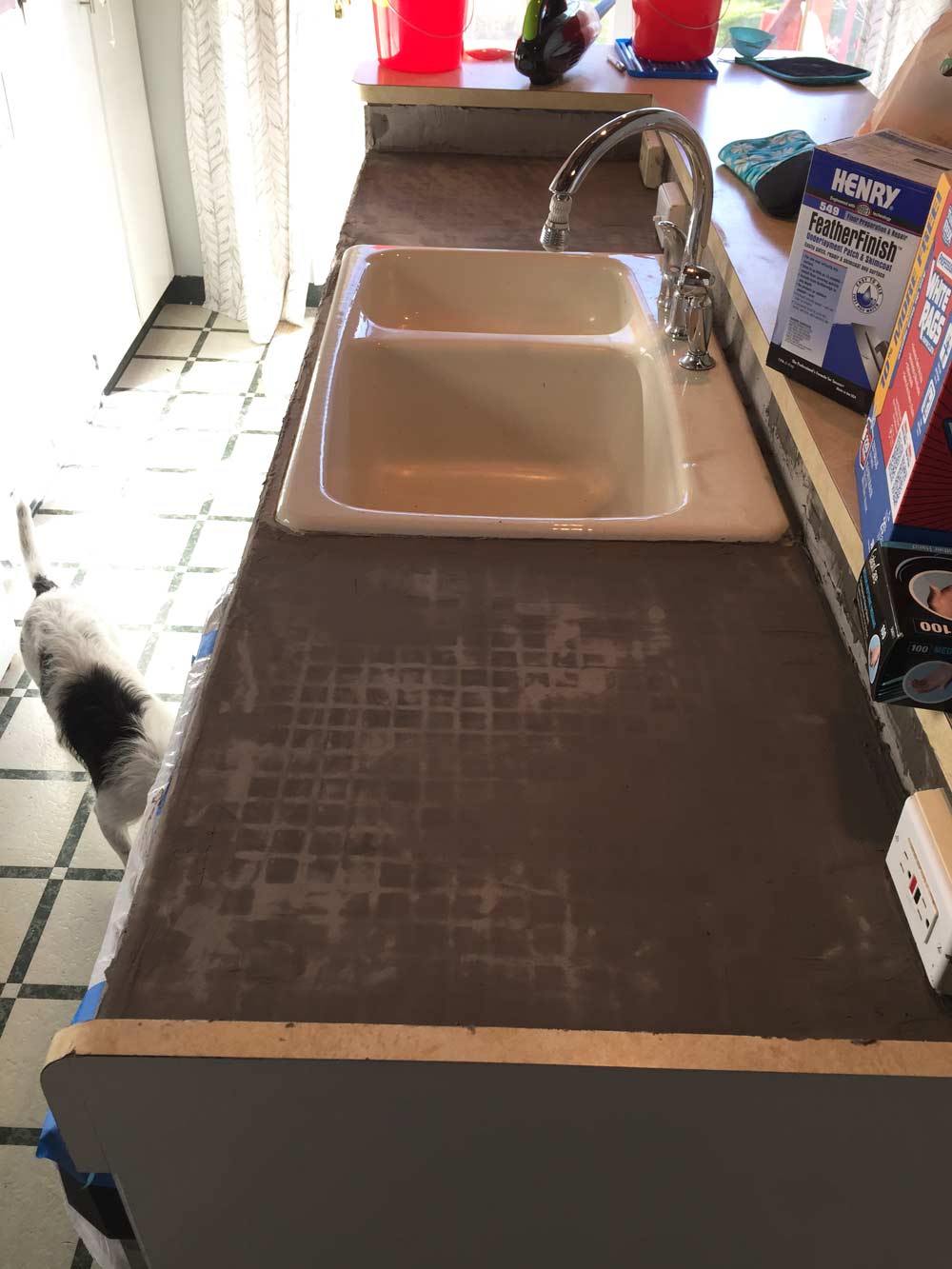 second coat of DIY feather finish concrete over tile counters on the island