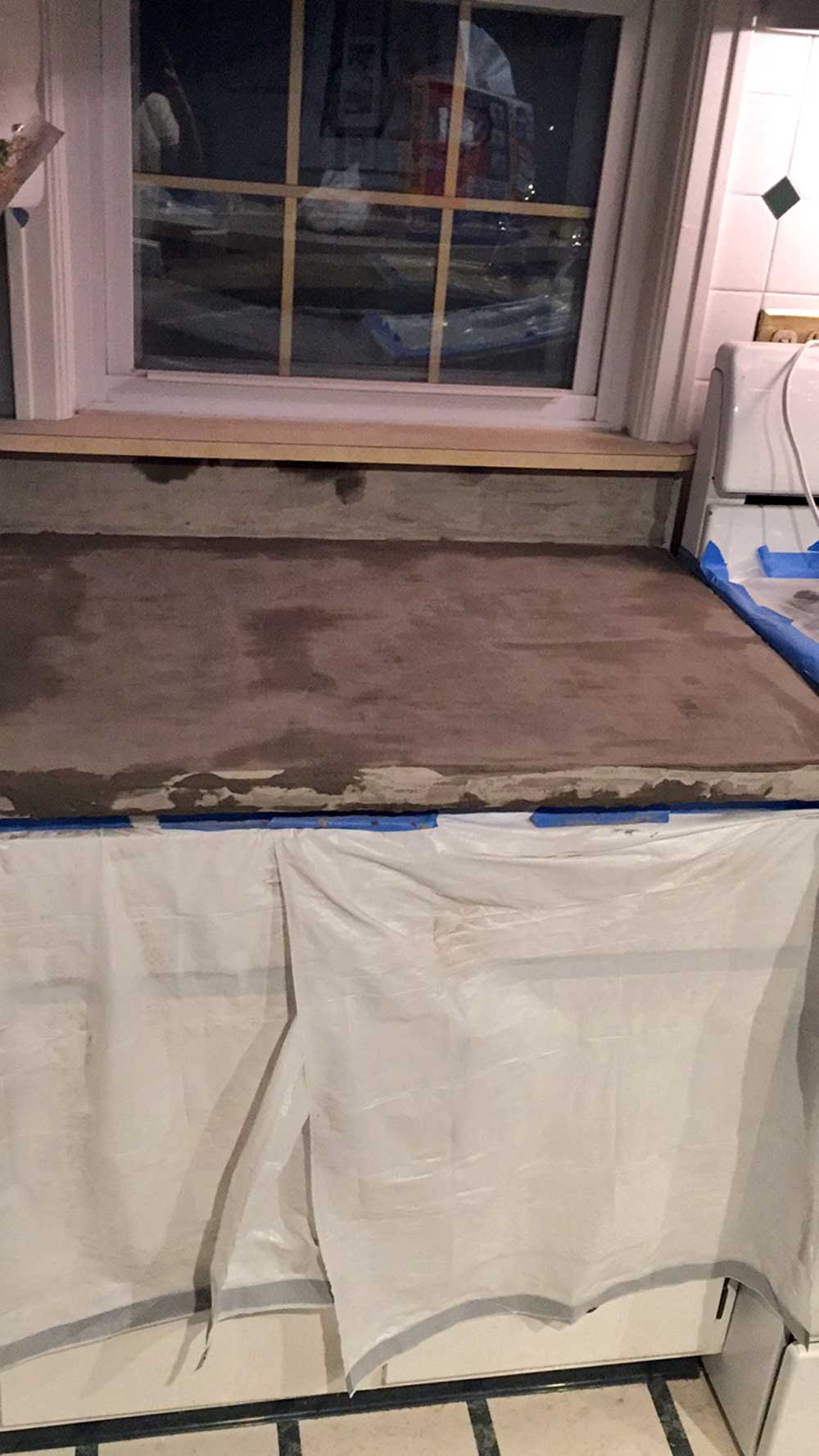 Touching up some gaps from sanding DIY feather finish concrete over tile counters