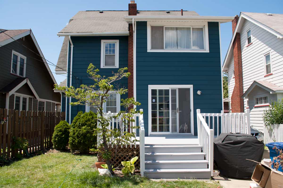 Dark teal house paint reveal. Paint color: Sherwin Williams Seaworthy with a fresh new deck